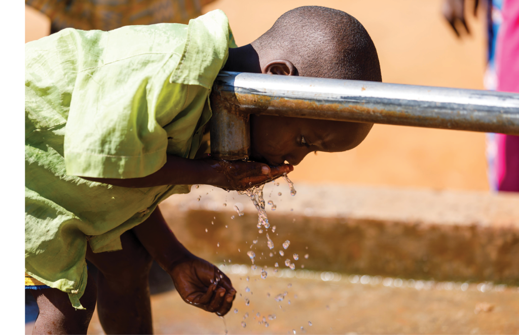 Boy drinking water from fountain