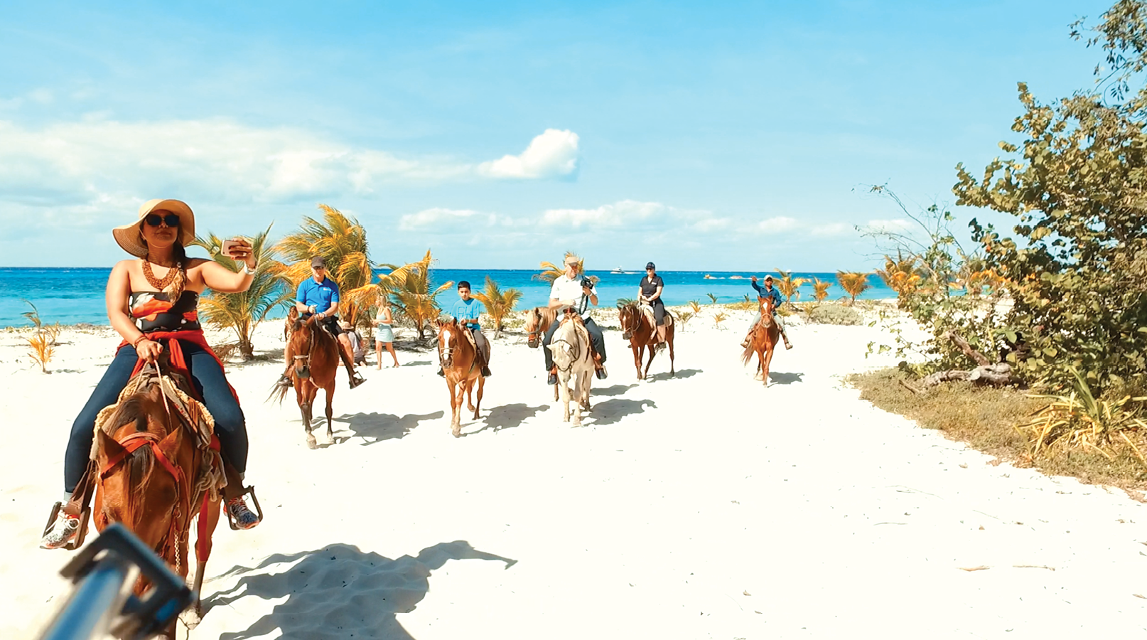 People Riding on Horseback on a beach