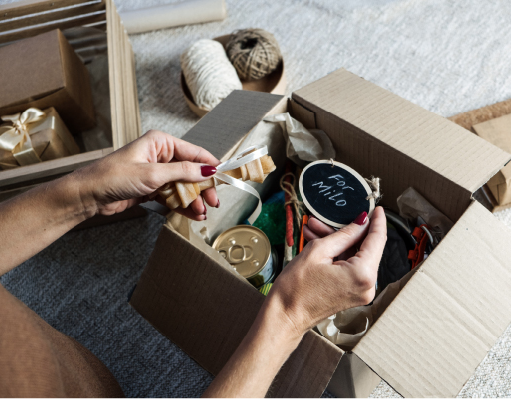 Female hands put stuff in Pet Subscription Box